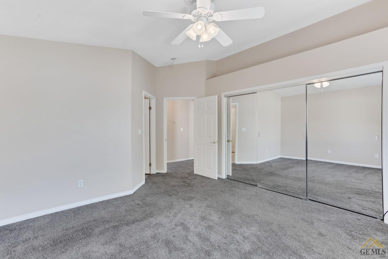 Undisclosed Address Bakersfield, CA 93311 - Photo 23 of 39 an empty room with closet and a chandelier fan