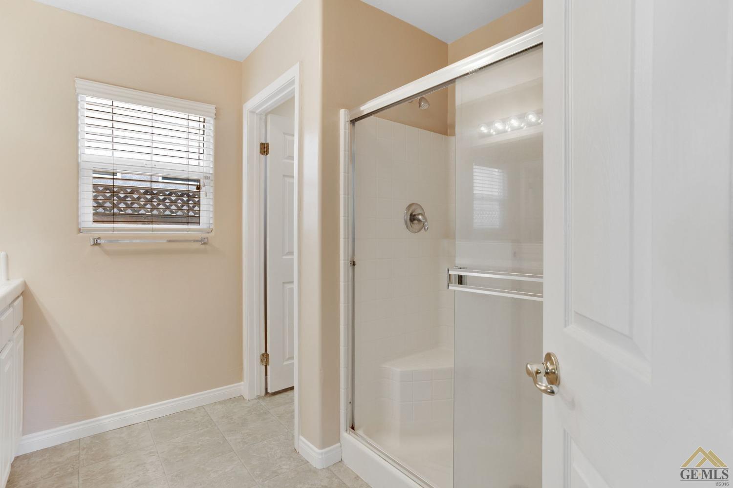 Undisclosed Address Bakersfield, CA 93311 - Photo 26 of 39 a bathroom with a glass shower door