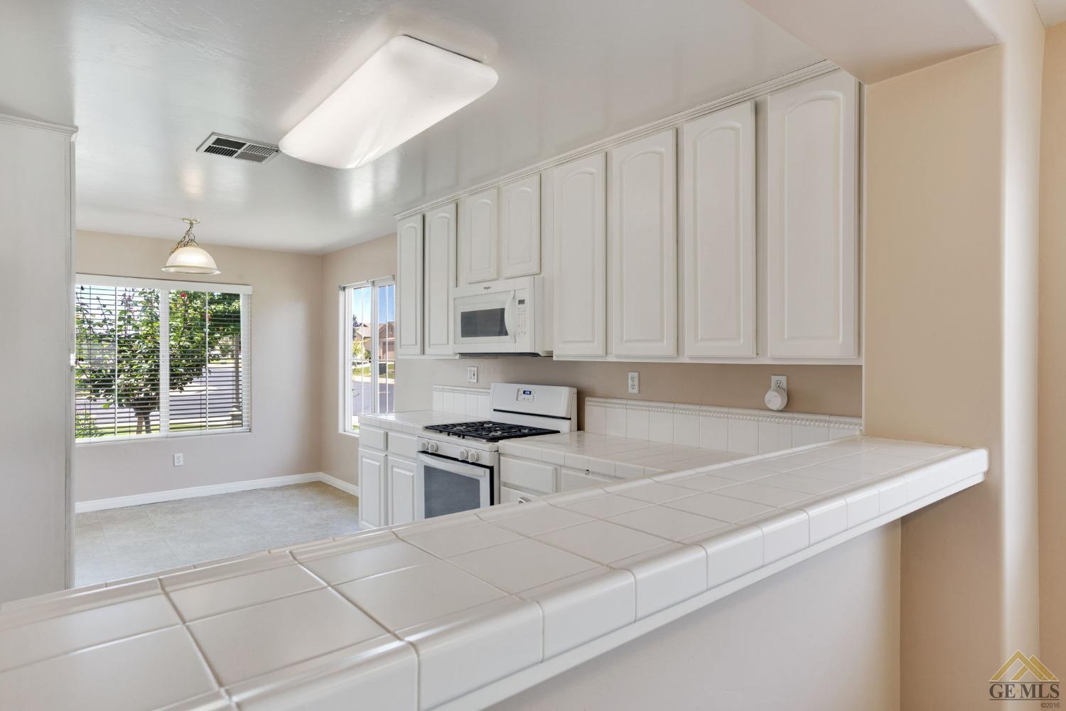 Undisclosed Address Bakersfield, CA 93311 - Photo 7 of 39 a kitchen with cabinets appliances and a window
