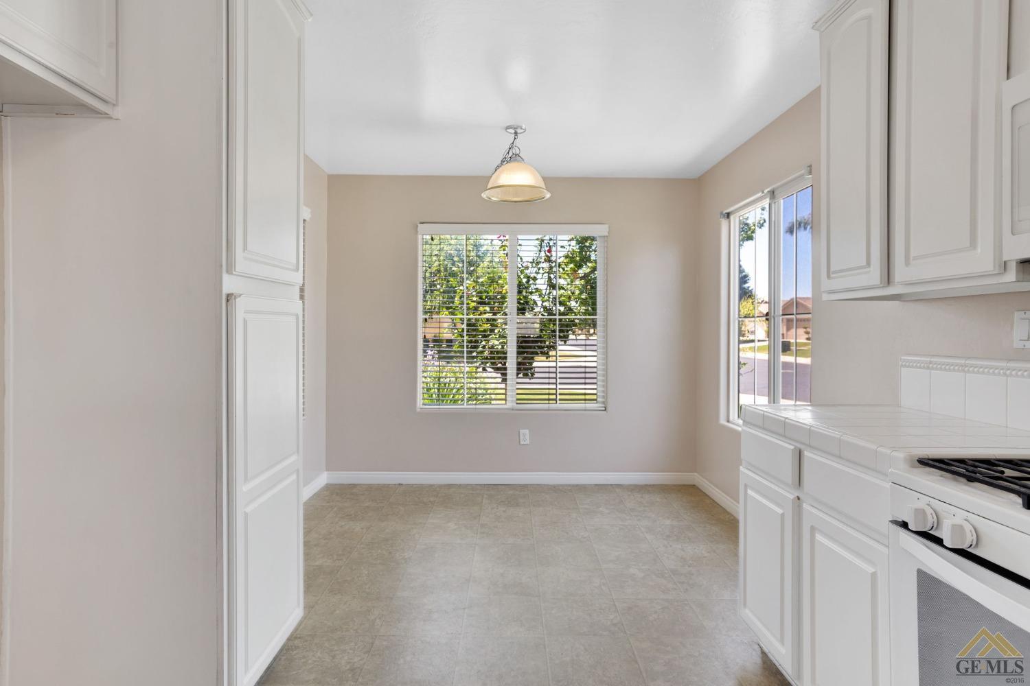 Undisclosed Address Bakersfield, CA 93311 - Photo 10 of 39 an empty room with windows and chandelier