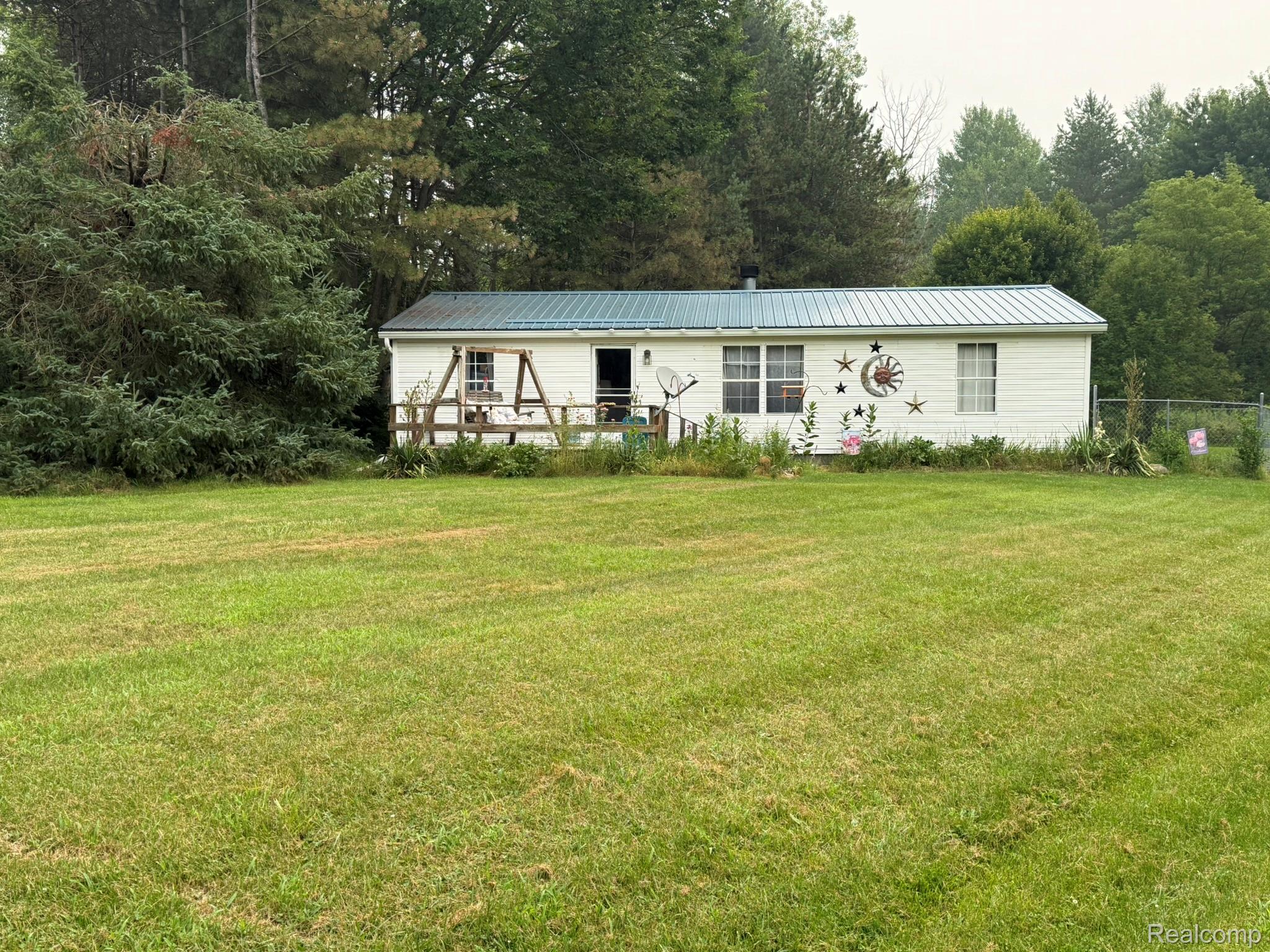 38 South Force Road Attica, MI 48412 - Photo 52 of 53 White-sided residence with a teal metal roof