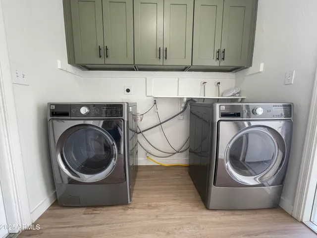 a utility room with sink dryer and washer