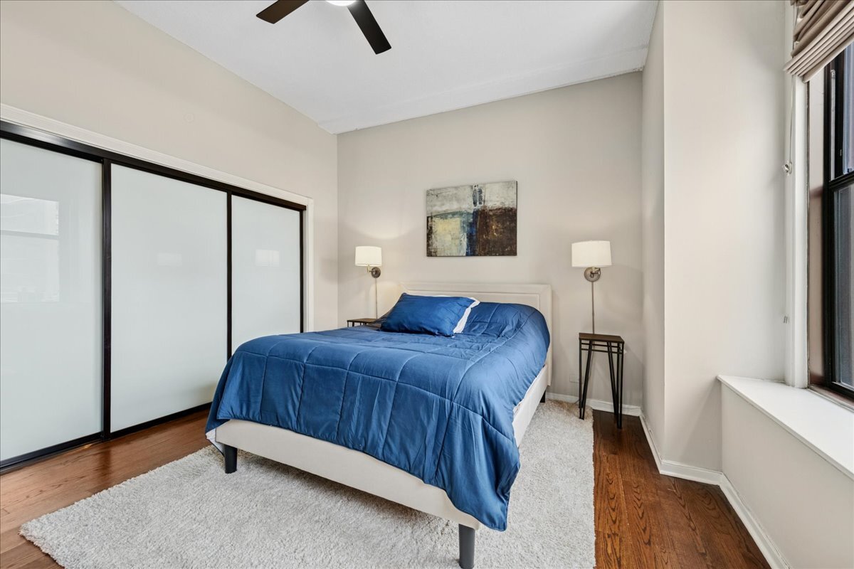 600 South Dearborn Street, Unit 601 Chicago, IL 60605 - Photo 15 of 18 a bedroom with a bed and a flat screen tv