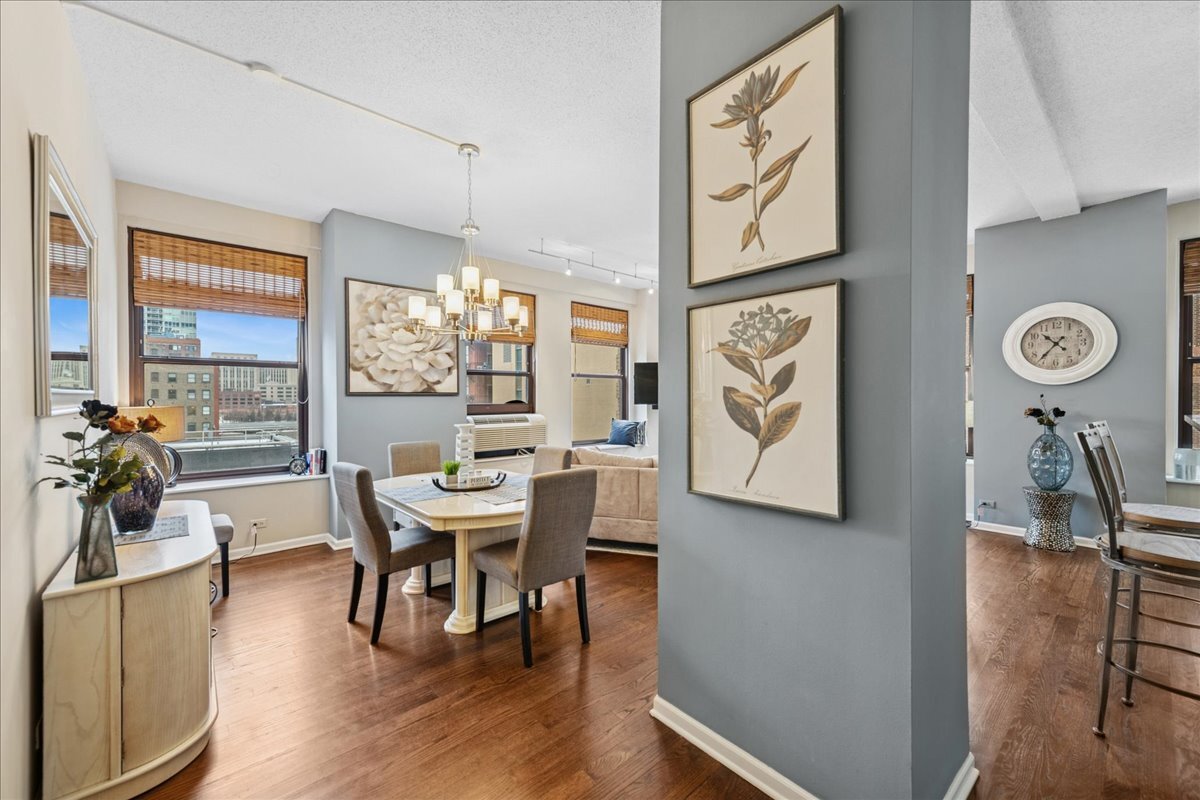 600 South Dearborn Street, Unit 601 Chicago, IL 60605 - Photo 4 of 18 a view of a dining room with furniture window and wooden floor