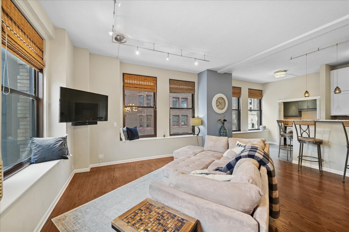 600 South Dearborn Street, Unit 601 Chicago, IL 60605 - Photo 7 of 18 a bedroom with furniture and a flat screen tv