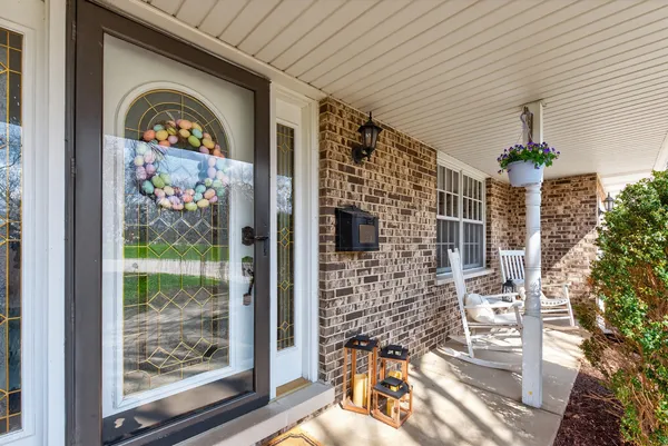 a kitchen with stainless steel appliances kitchen island granite countertop a stove a sink a dining table and chairs