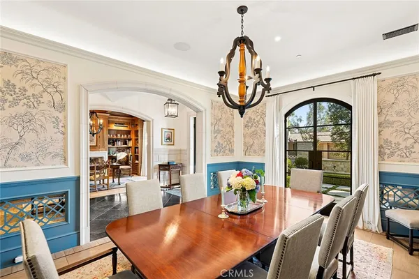 a living room with furniture a fireplace and large windows