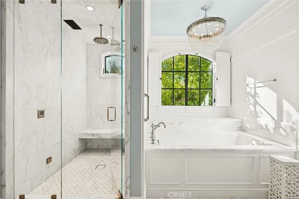 a bathroom with a shower sink vanity and mirror