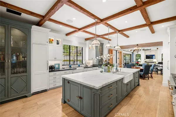 a large white kitchen with a large window