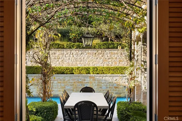 a view of swimming pool with outdoor seating and plants