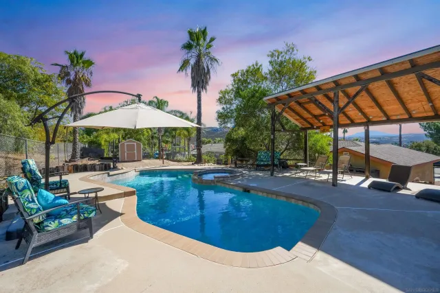 a view of a swimming pool with sitting area