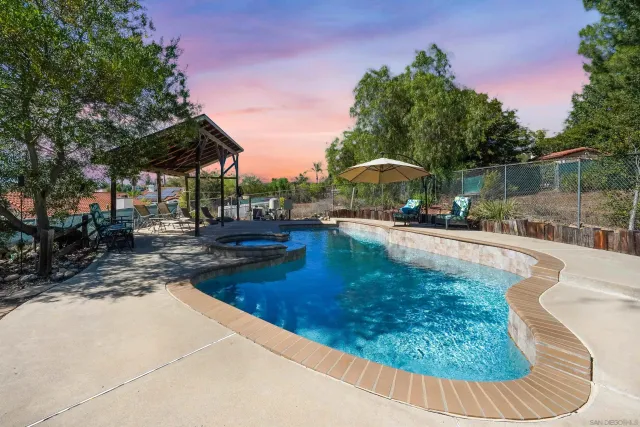 a swimming pool with outdoor seating and yard