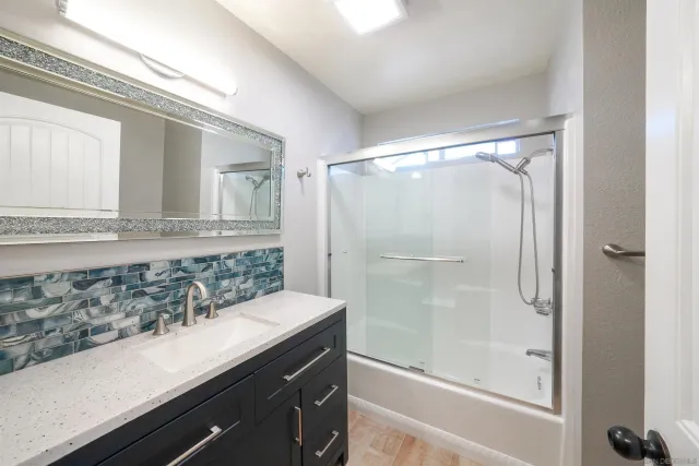 a bathroom with a shower and a sink