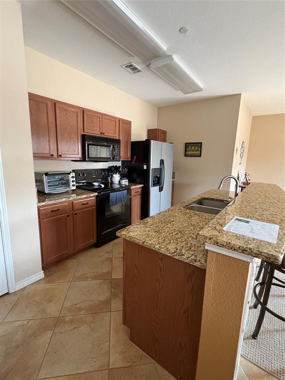 5900 Stone Mountain Road The Colony, TX 75056 - Photo 5 of 15 a kitchen with stainless steel appliances granite countertop a sink stove and refrigerator