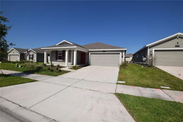 a front view of a house with a yard and garage