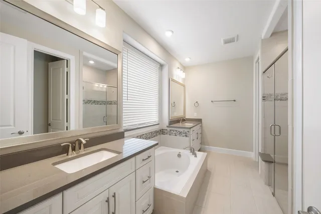 a spacious bathroom with a double vanity sink mirror and double