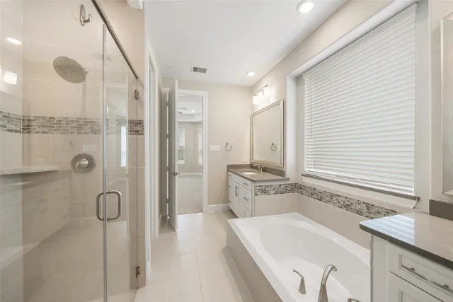 a bathroom with a granite countertop sink a shower and a mirror
