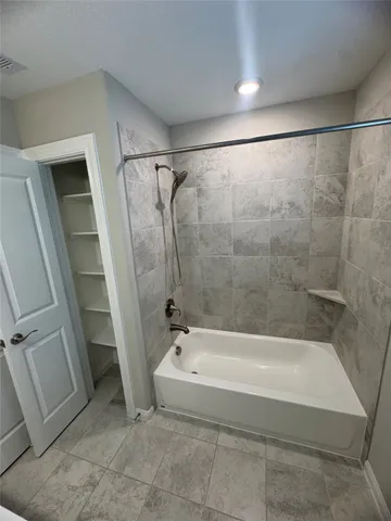 a spacious bathroom with a bathtub and a shower