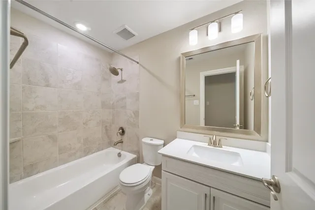 a bathroom with a sink toilet a bathtub and a vanity