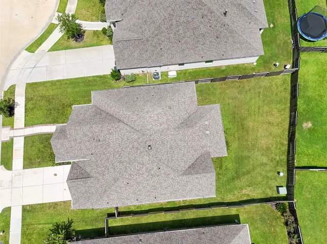 an aerial view of a house with garden space and pool view