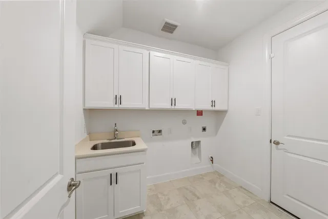 a kitchen with a sink and cabinets