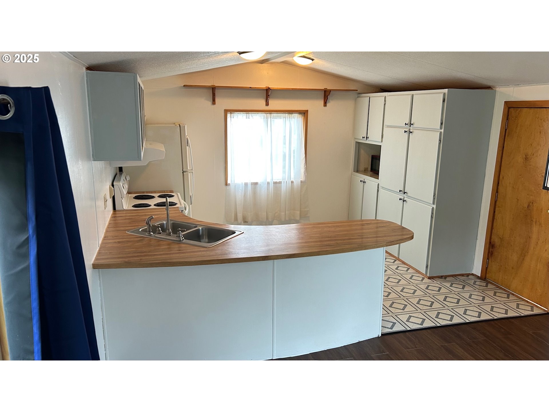 91323 Sandstone Lane, Unit 418 Coos Bay, OR 97420 - Photo 6 of 20 a living room with wooden floor and large window