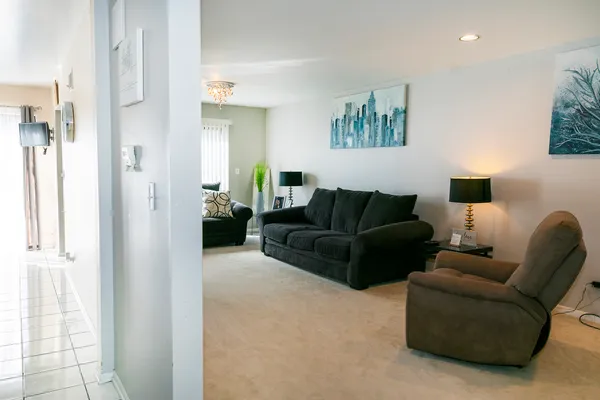 a living room with furniture and a glass door