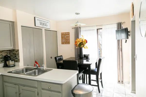 a kitchen with a table and chairs