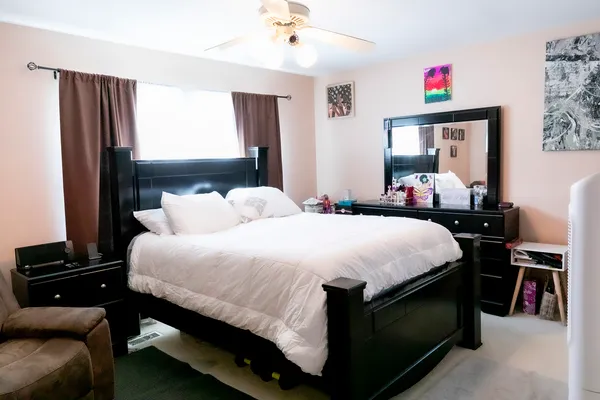 a bedroom with a bed and a window