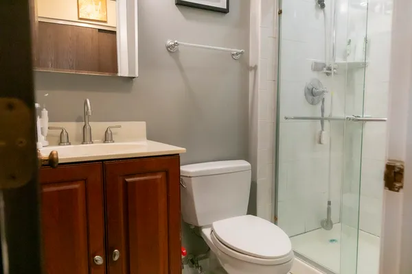 a bathroom with a toilet a sink and shower