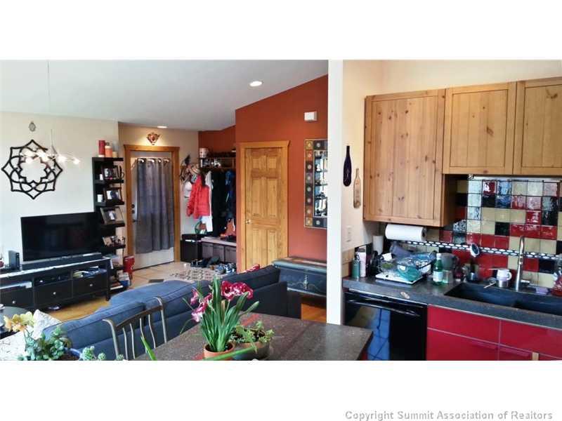 960 Mesa Drive Silverthorne, CO 80498 - Photo 19 of 25 a kitchen with stainless steel appliances kitchen island granite countertop a stove a sink and a microwave