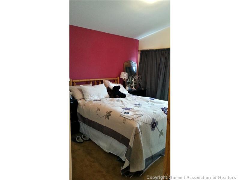 960 Mesa Drive Silverthorne, CO 80498 - Photo 24 of 25 a bed sitting in a bedroom next to a window