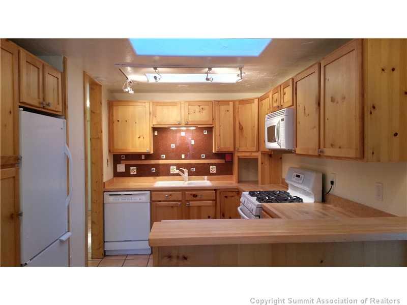 960 Mesa Drive Silverthorne, CO 80498 - Photo 8 of 25 a kitchen with stainless steel appliances kitchen island granite countertop a sink and cabinets