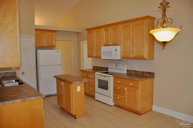 a kitchen with stainless steel appliances granite countertop a stove a refrigerator and a refrigerator
