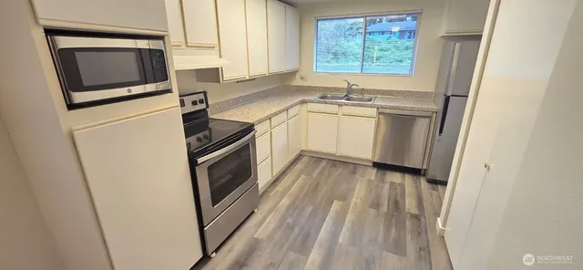 a kitchen with a refrigerator stove and sink