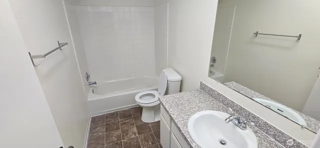 a view of a yard with plants and large trees