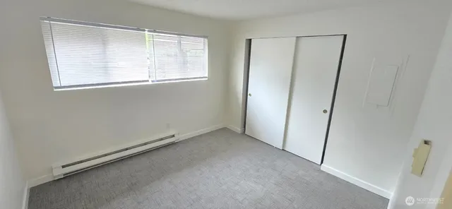 a view of a hallway with wooden shelves