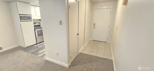 a view of kitchen with refrigerator and window
