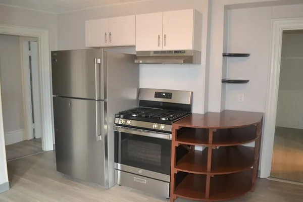 a kitchen with stainless steel appliances a refrigerator and a stove