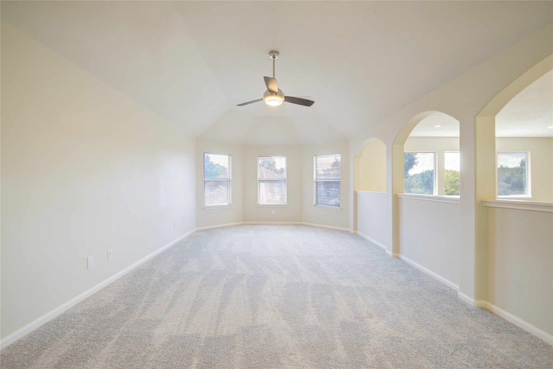 14411 Chartley Falls Drive Houston, TX 77044 - Photo 22 of 36 an empty room with chandelier fan and windows