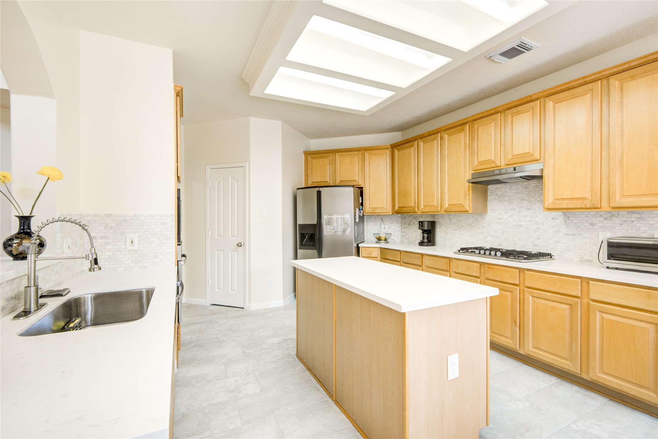 14411 Chartley Falls Drive Houston, TX 77044 - Photo 25 of 36 a kitchen with a sink stove top oven and refrigerator