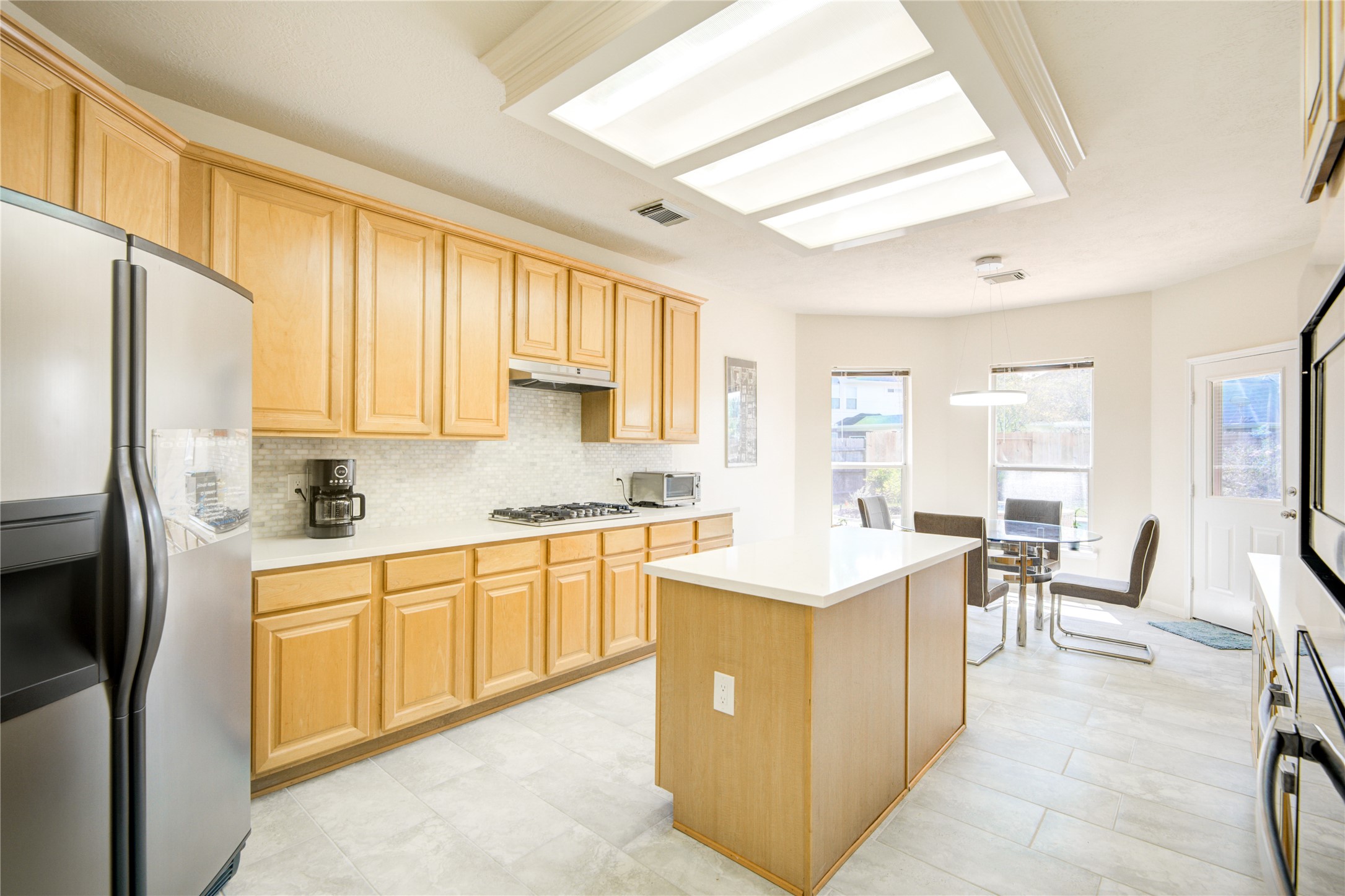 14411 Chartley Falls Drive Houston, TX 77044 - Photo 27 of 36 a large white kitchen with cabinets