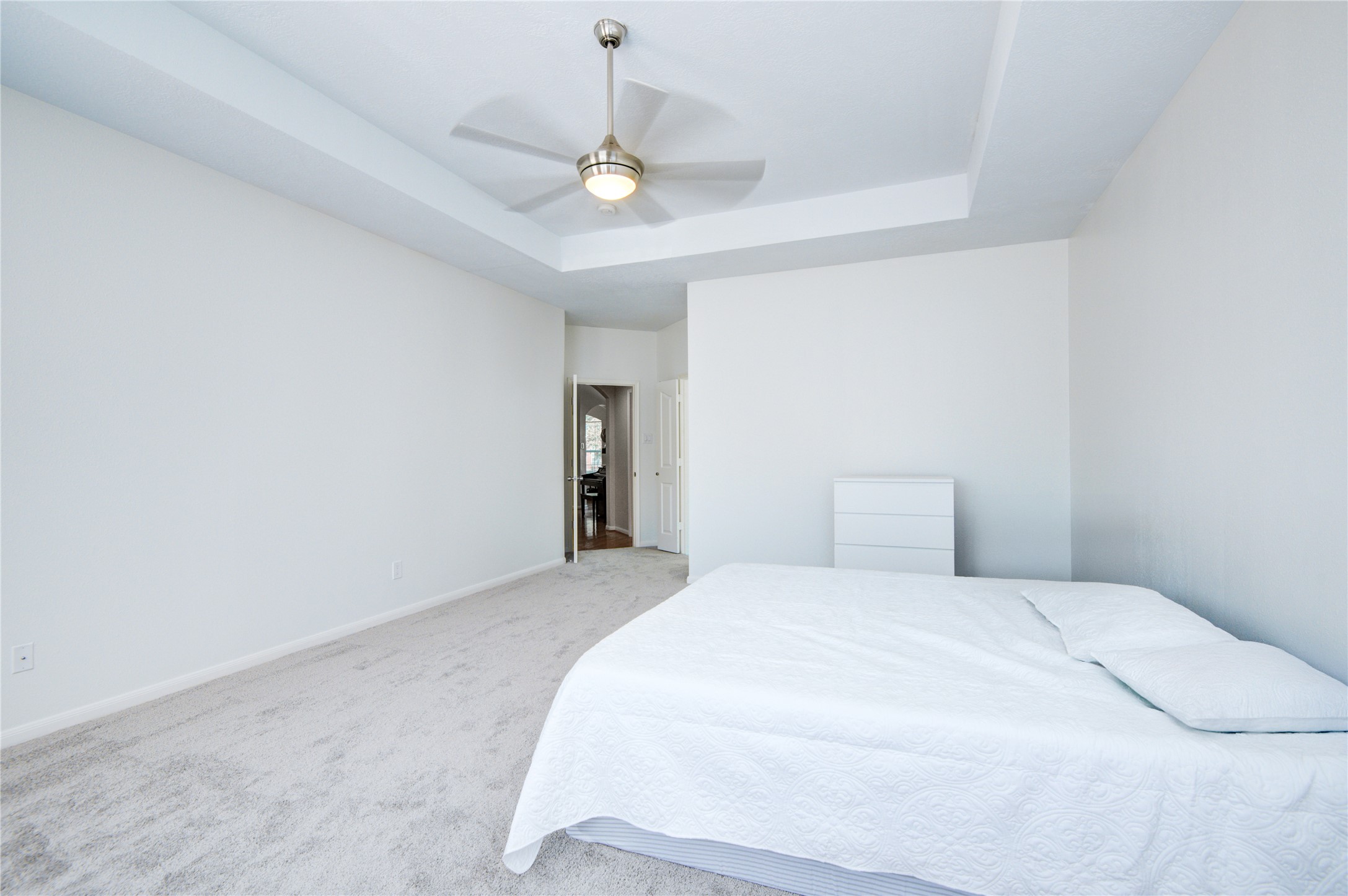 14411 Chartley Falls Drive Houston, TX 77044 - Photo 32 of 36 a bedroom with a bed and a chandelier