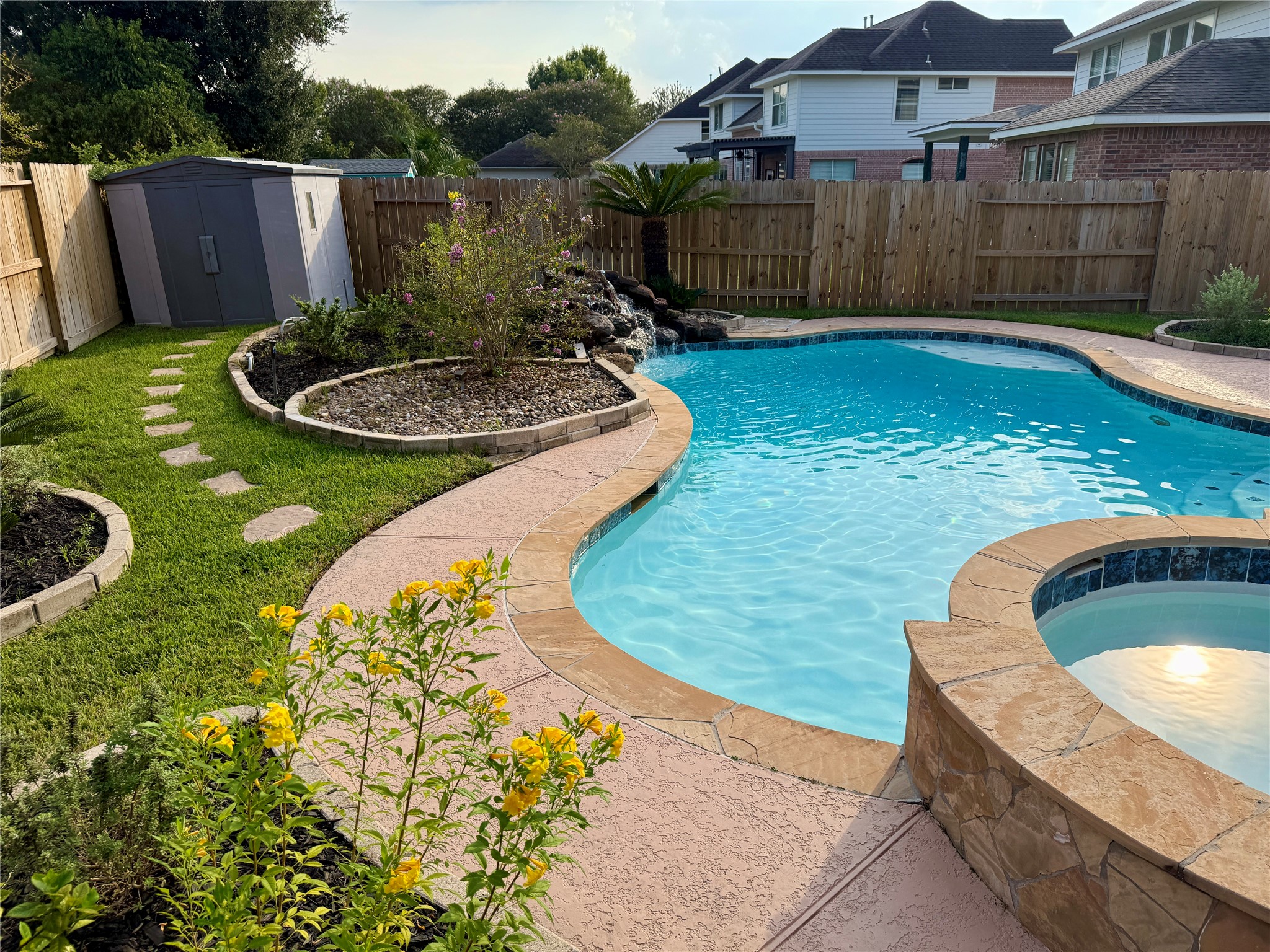 14411 Chartley Falls Drive Houston, TX 77044 - Photo 7 of 36 a backyard of a house with yard and fountain