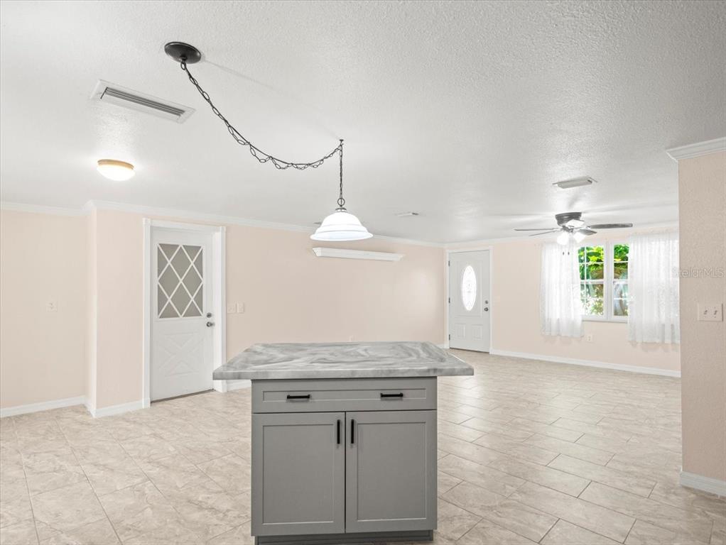3408 Crape Myrtle Drive Hernando Beach, FL 34607 - Photo 12 of 46 a view of a kitchen with a sink and chandelier
