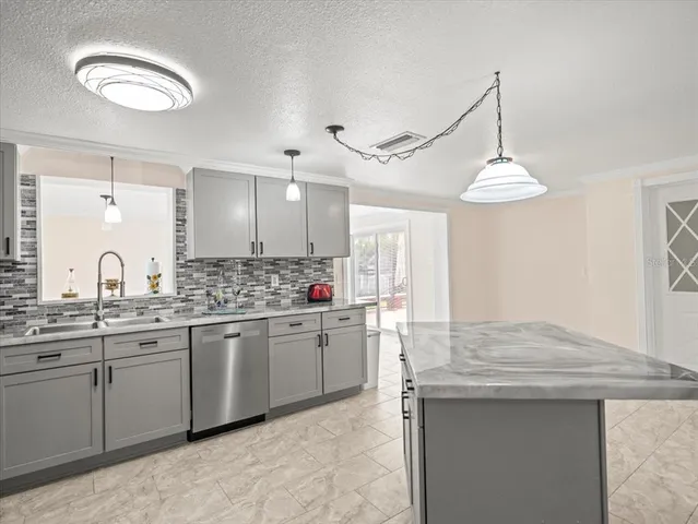 a kitchen with sink cabinets and window