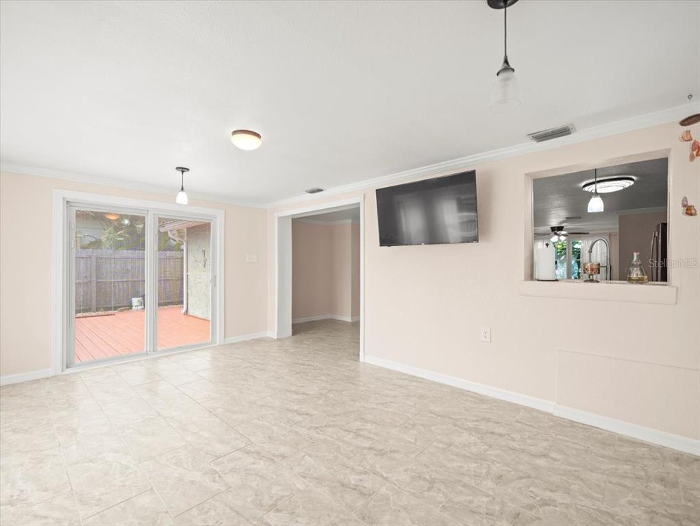 3408 Crape Myrtle Drive Hernando Beach, FL 34607 - Photo 19 of 46 a view of an empty room with a window and a kitchen view