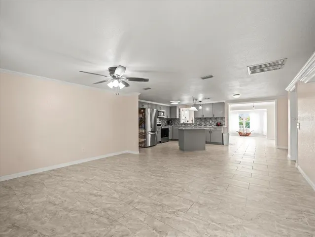 a view of a kitchen with a sink and a refrigerator