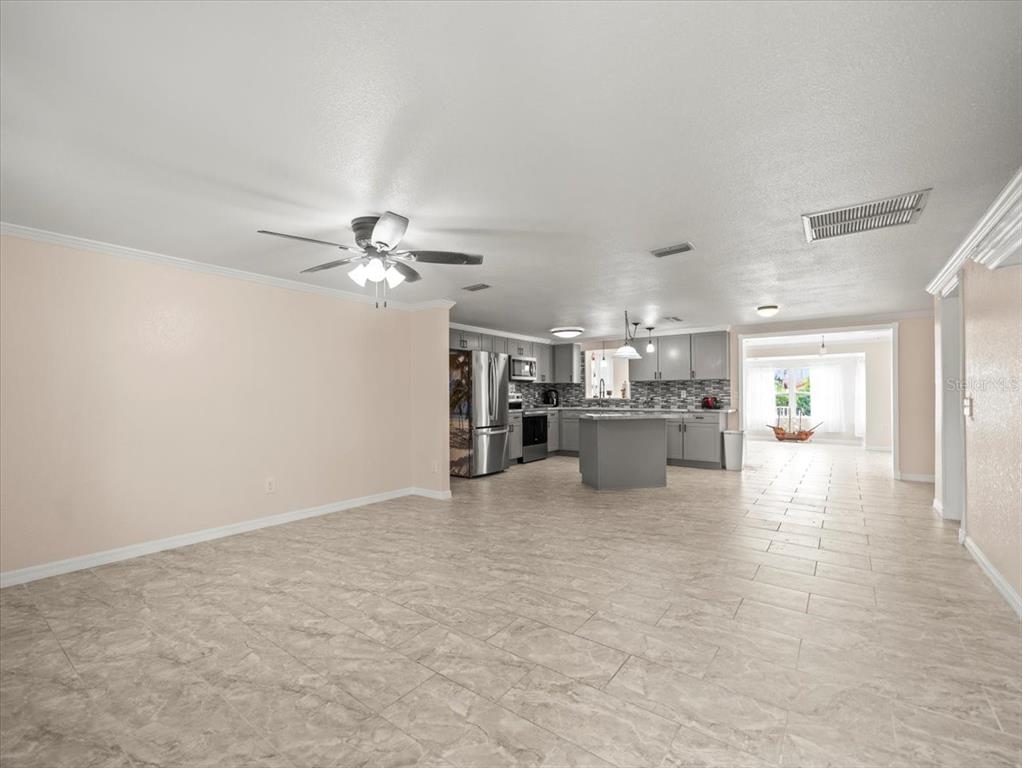 3408 Crape Myrtle Drive Hernando Beach, FL 34607 - Photo 5 of 46 a view of a kitchen with a sink and a refrigerator