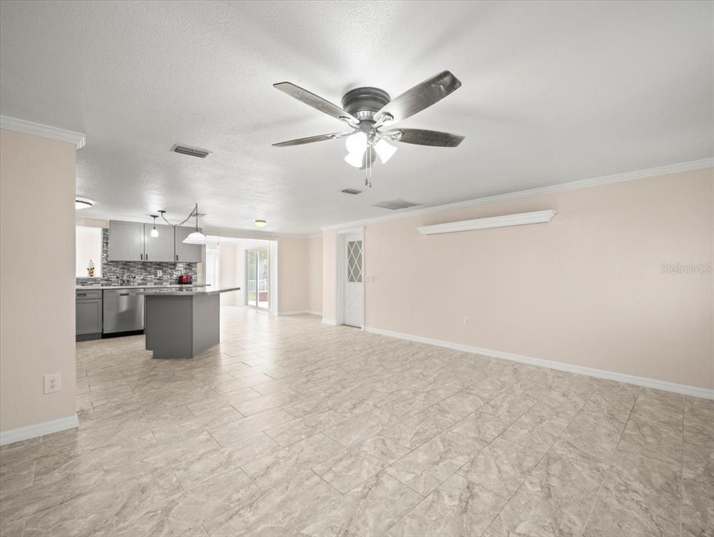3408 Crape Myrtle Drive Hernando Beach, FL 34607 - Photo 8 of 46 a view of kitchen with kitchen island a sink stainless steel appliances cabinets and a refrigerator